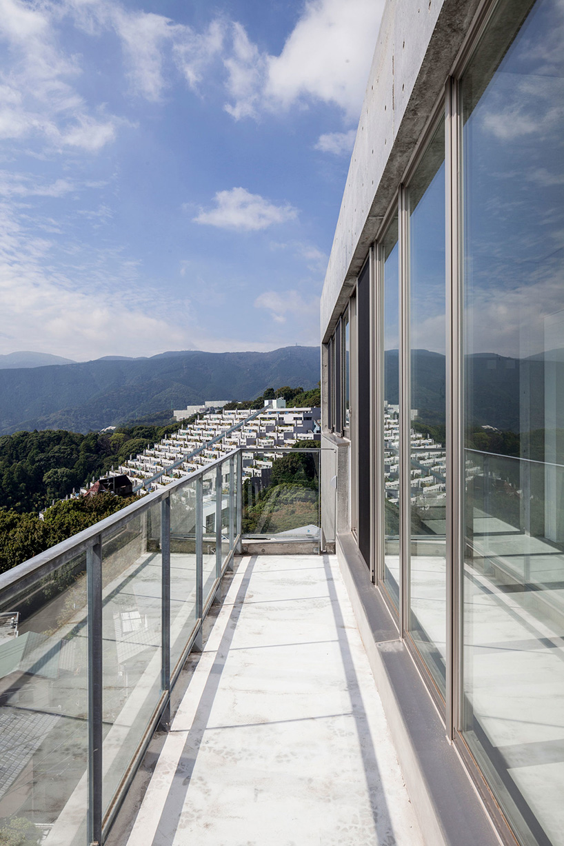 ashida architects sets concrete atami tower house on a steep slope in japan