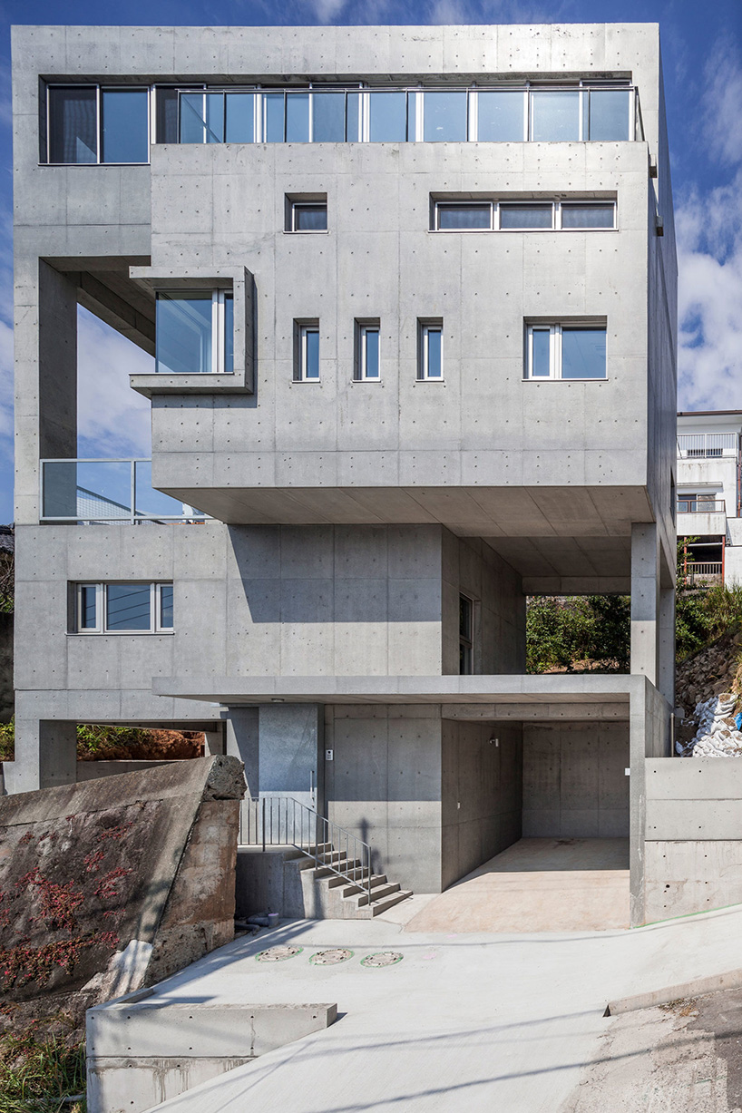 ashida architects sets concrete atami tower house on a steep slope in japan