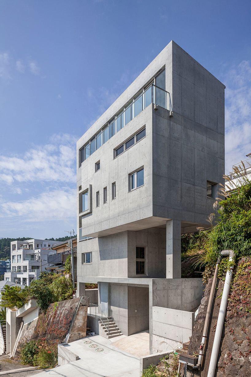 ashida architects sets concrete atami tower house on a steep slope in japan