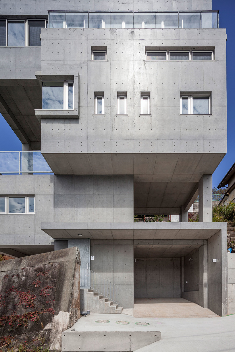 ashida architects sets concrete atami tower house on a steep slope in japan