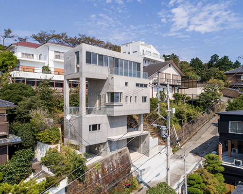 ashida architects sets concrete atami tower house on a steep slope in japan