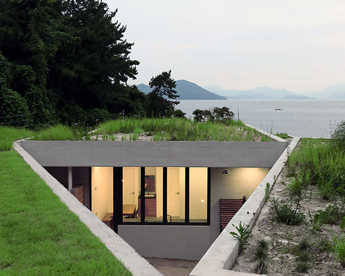 BCHO architects embeds a concrete guesthouse into the coast of south korea