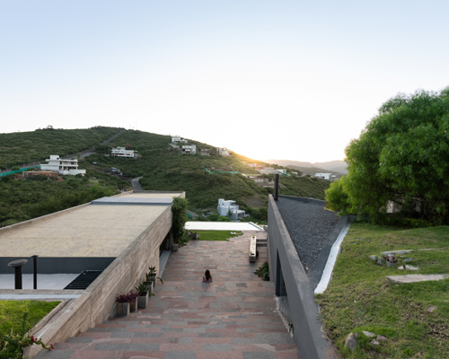 the underground 'casa en la cuesta' overlooks the rolling mountains of argentina