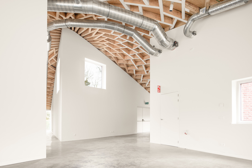 a conic roof of complex timber tops frans masereel centrum pavilion in belgium