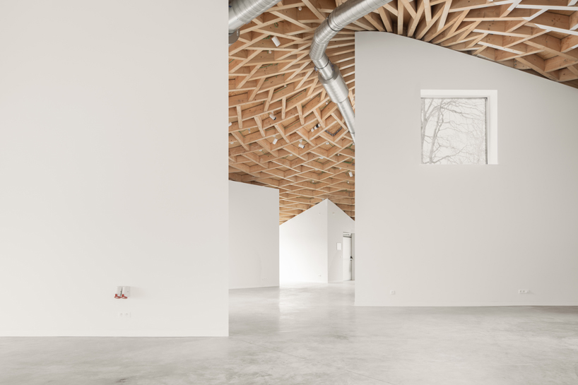 a conic roof of complex timber tops frans masereel centrum pavilion in belgium