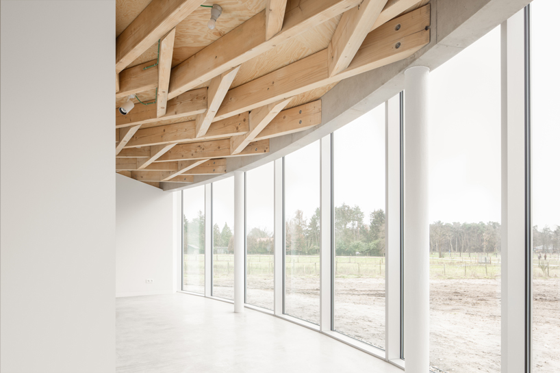 a conic roof of complex timber tops frans masereel centrum pavilion in belgium