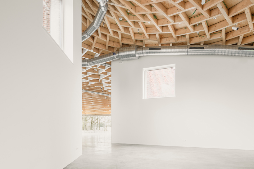 paris-based studio LIST and japanese architect hideyuki nakayama architects a conic roof of complex timber tops the frans masereel centrum pavilion in belgium