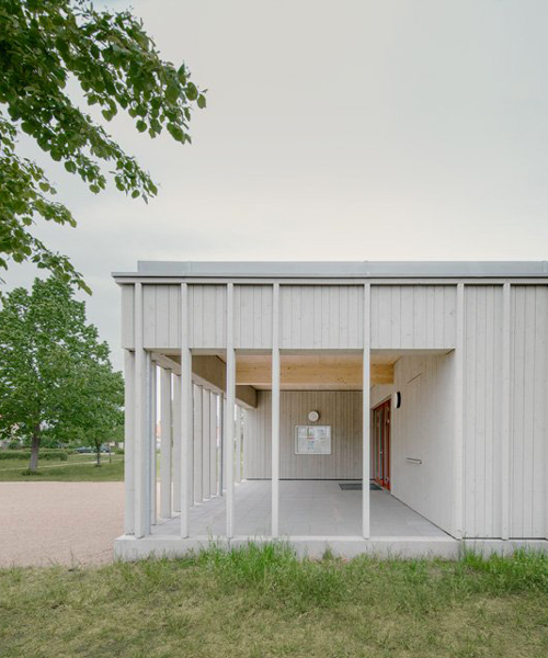 gray finished larch timber clads ko/ok architektur's new sports venue in germany
