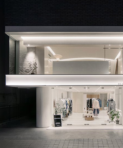 labotory contrasts rough rocks with sophisticated clothes in seoul showroom