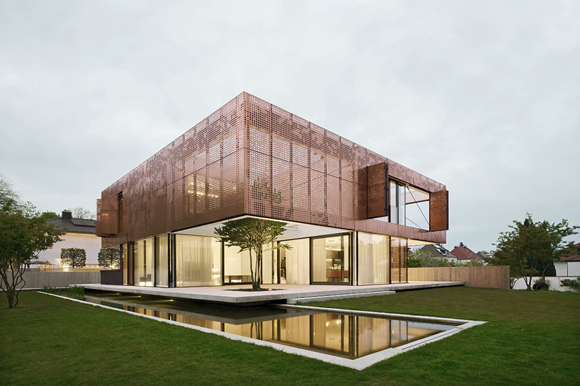 liebel architekten wraps house in niederbayern, germany, in perforated copper façade