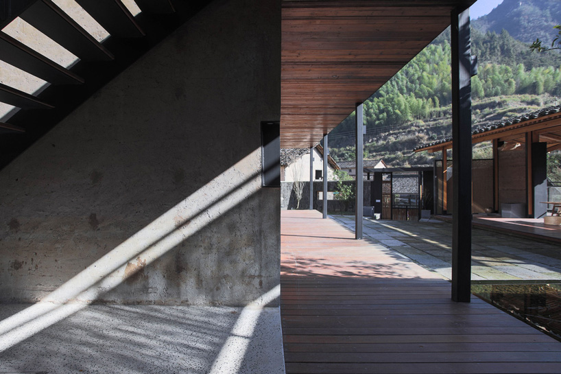 shulin architectural design sets stone + wood hotel within an ancient village in china