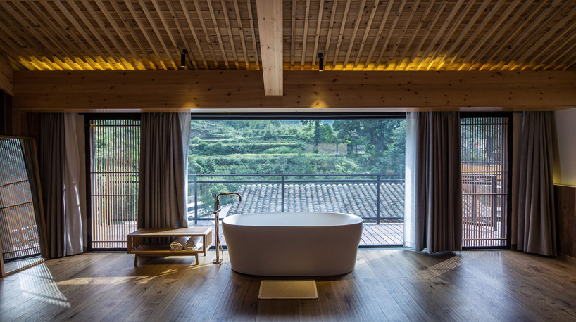 shulin architectural design sets stone + wood hotel within an ancient village in china