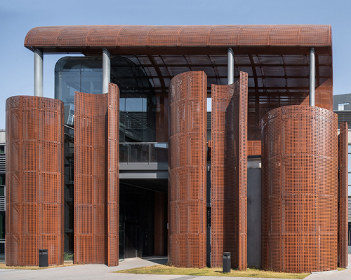 tanghua architects adds rusty red arcade to shenzhen's international art design center