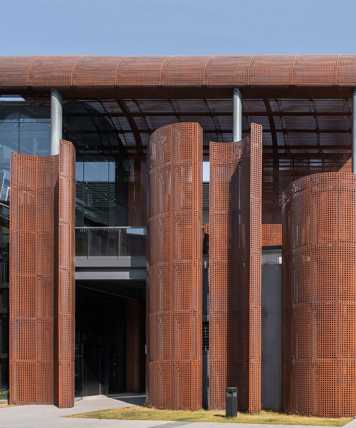 tanghua architects adds rusty red arcade to shenzhen's international art design center