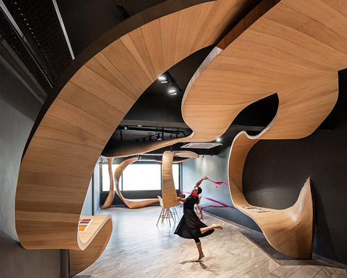 studio ardete fills shop's interiors with a flowing wooden ribbon in india