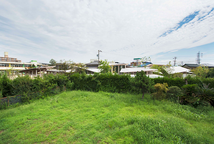 studio velocity hides japanese 'house on the hedge' behind green barriers