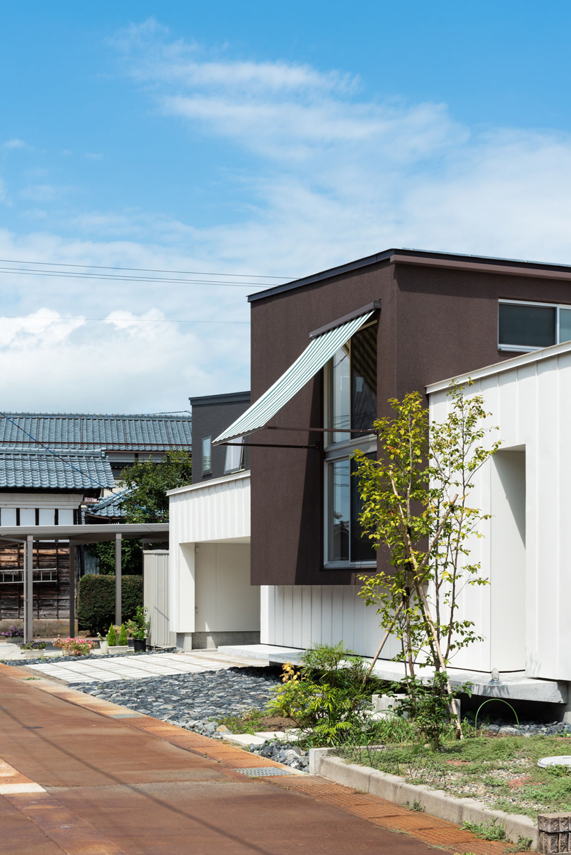 two contrasting volumes intersect in takeru shoji architects' house in kitanyuugura, japan