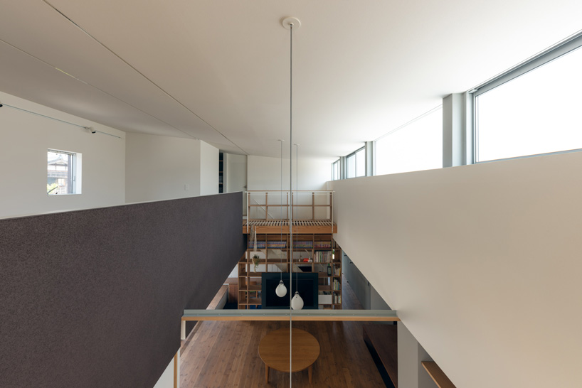 two contrasting volumes intersect in takeru shoji architects' house in kitanyuugura, japan