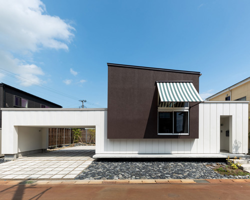 two contrasting volumes intersect in takeru shoji architects' house in kitanyuugura, japan