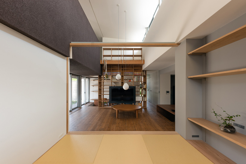 two contrasting volumes intersect in takeru shoji architects' house in kitanyuugura, japan