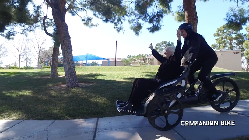 the companion bike lets wheelchair users ride in tandem