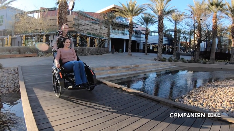 the companion bike lets wheelchair users ride in tandem