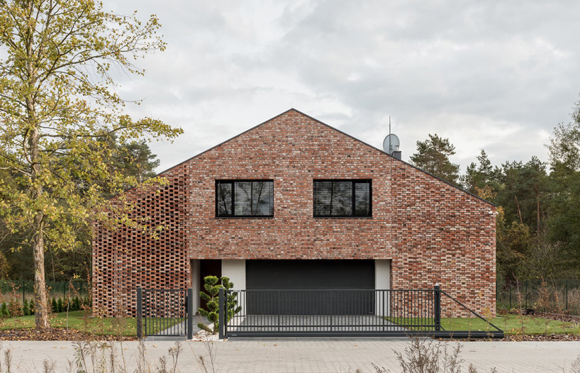 wrzeszcz architekci uses bricks from an old barn to build new house in poland