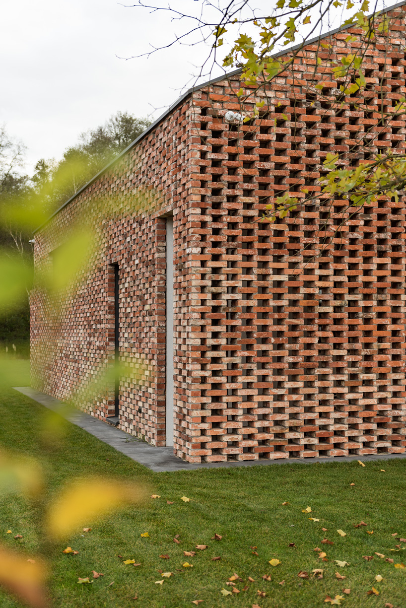 wrzeszcz architekci uses bricks from an old barn to build new house in poland