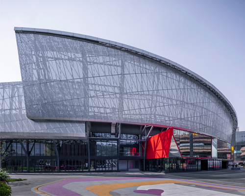 colored metal boxes protrude from urbantect's banan stadium in chongqing, china
