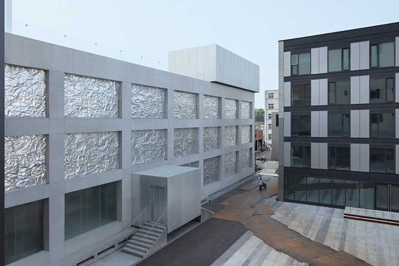 M WOODS hutong in beijing features façade of folded galvanized steel sheets