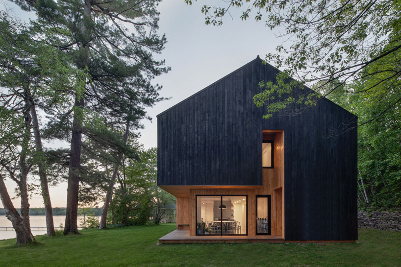 charred timber and receding volumes define atelier schwimmer's lakeside chalet in quebec designboom