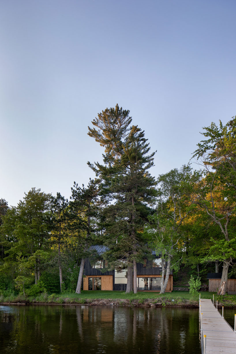 charred timber and receding volumes define atelier schwimmer's lakeside chalet in quebec designboom