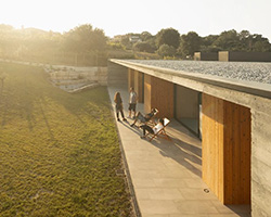 contaminar integrates L shaped house into olive tree valley in portugal