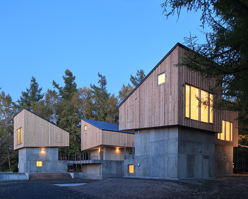 kenta sano and associates builds group of five villa cottages on a hill in biei village, japan
