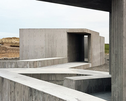 lie øyen arkitekter adds concrete service building to norwegian sandy beach