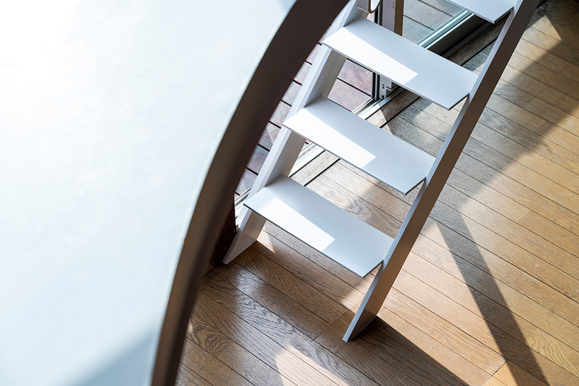 mtka adds inhabitable elliptical void below the roof of this house in tokyo