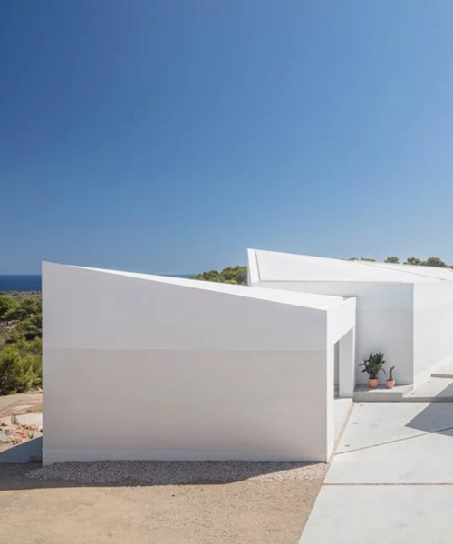 nomo studio lifts white polyhedral volumes above spanish landscape