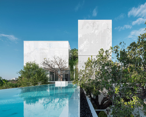 ayutt and associates design places aluminum-clad house within natural ecosystem in thailand