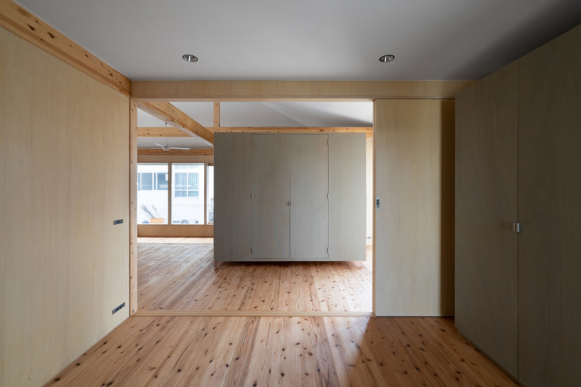 studio monaka lifts wooden house on set of concrete foundations in japan