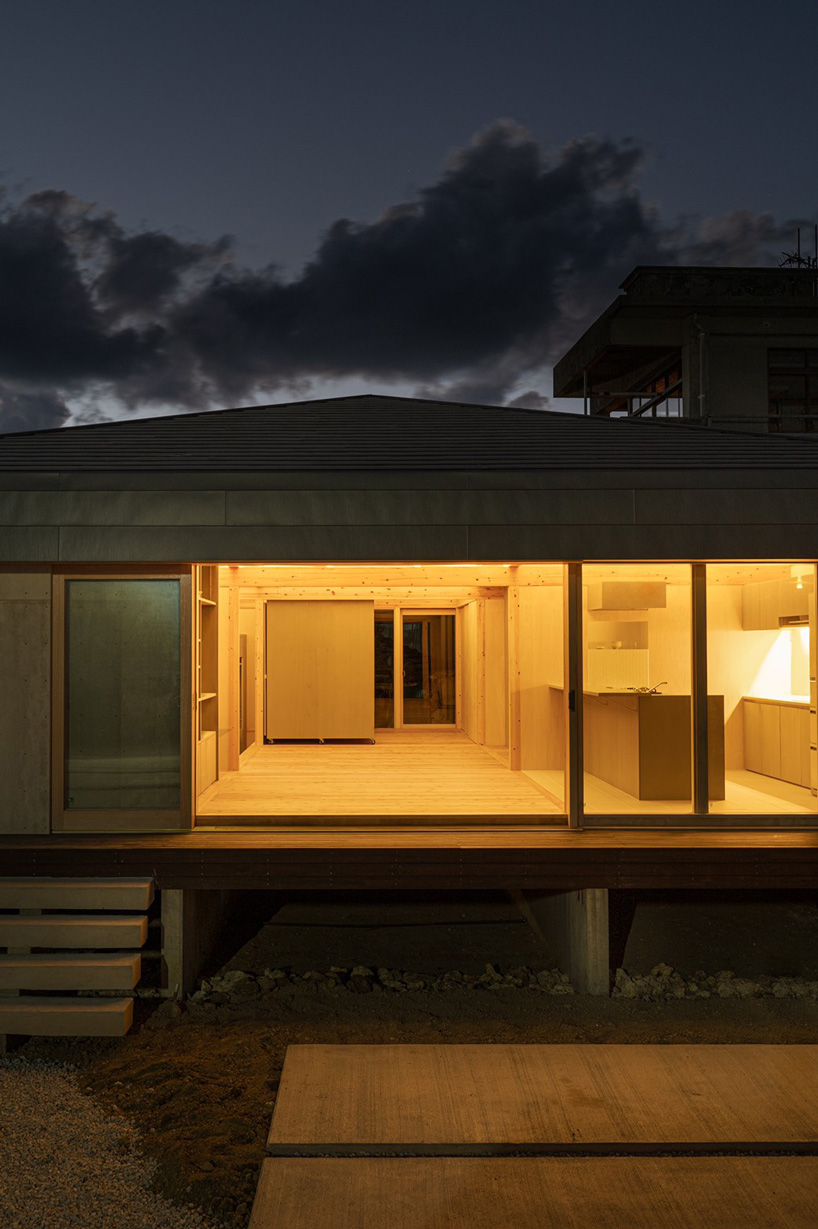 studio monaka lifts wooden house on set of concrete foundations in japan