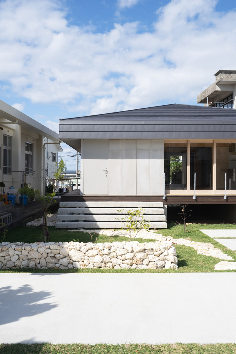 studio monaka lifts wooden house on set of concrete foundations in japan