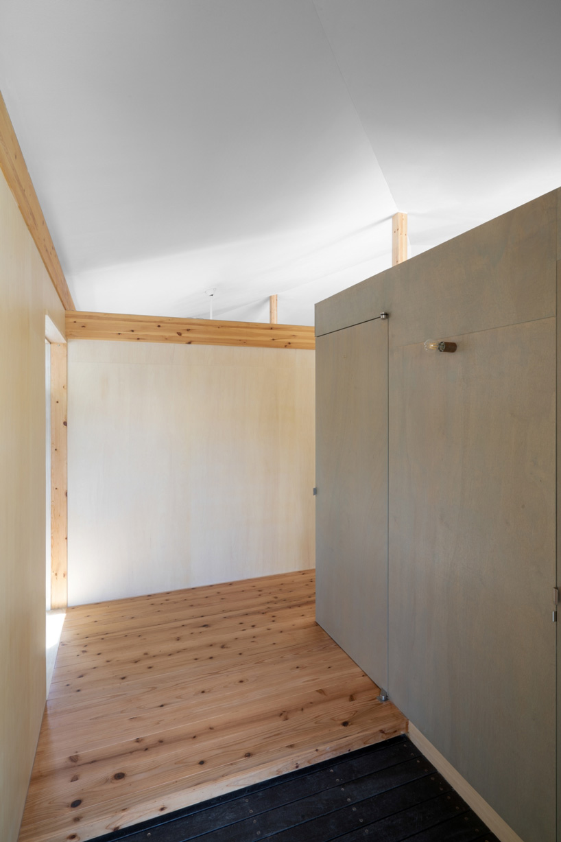 studio monaka lifts wooden house on set of concrete foundations in japan