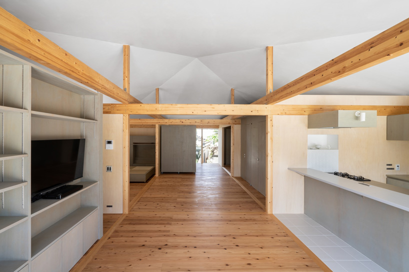 studio monaka lifts wooden house on set of concrete foundations in japan