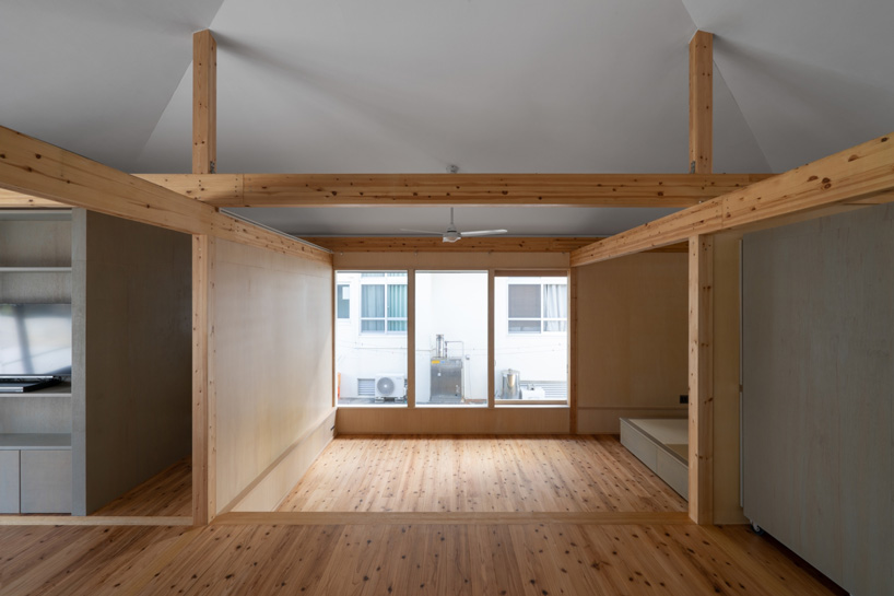 studio monaka lifts wooden house on set of concrete foundations in japan