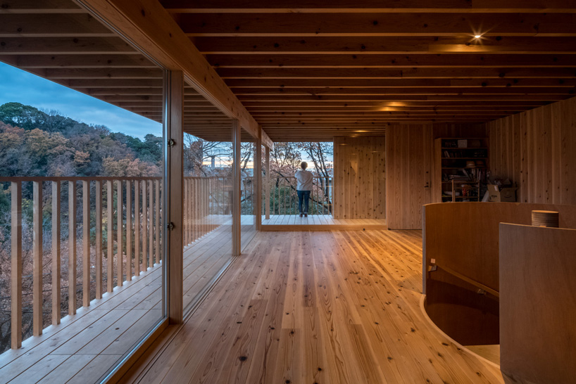 tomoaki uno architects places concrete + wood residence on steep slope in japan