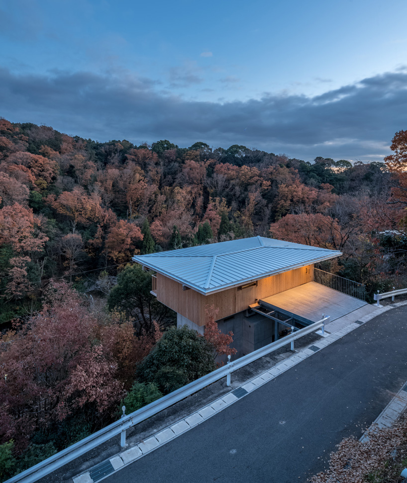tomoaki uno architects places concrete + wood residence on steep slope in japan