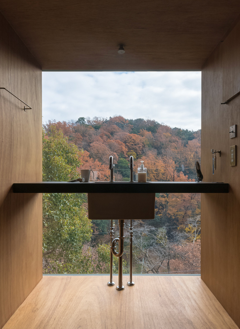 tomoaki uno architects places concrete + wood residence on steep slope in japan