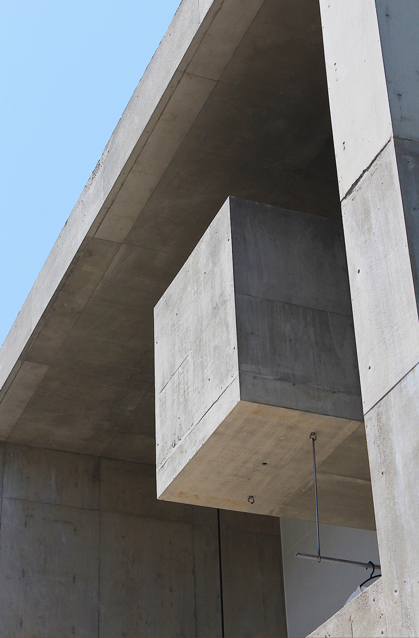 tomoaki uno architects builds concrete cuboid house with protruding balconies in japan