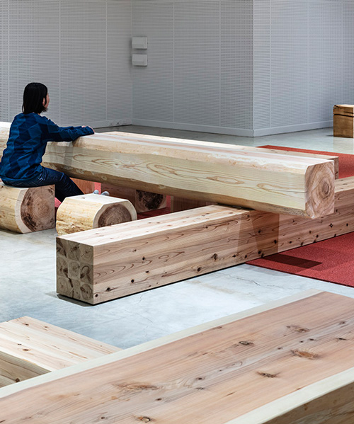 torafu architects renovates museum gallery with cedar logs as benches and tables in japan