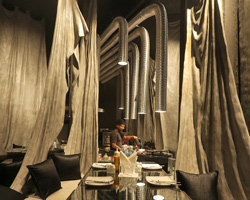 wallmakers divides 'tease me' café in india using drapes finished with ferrocement